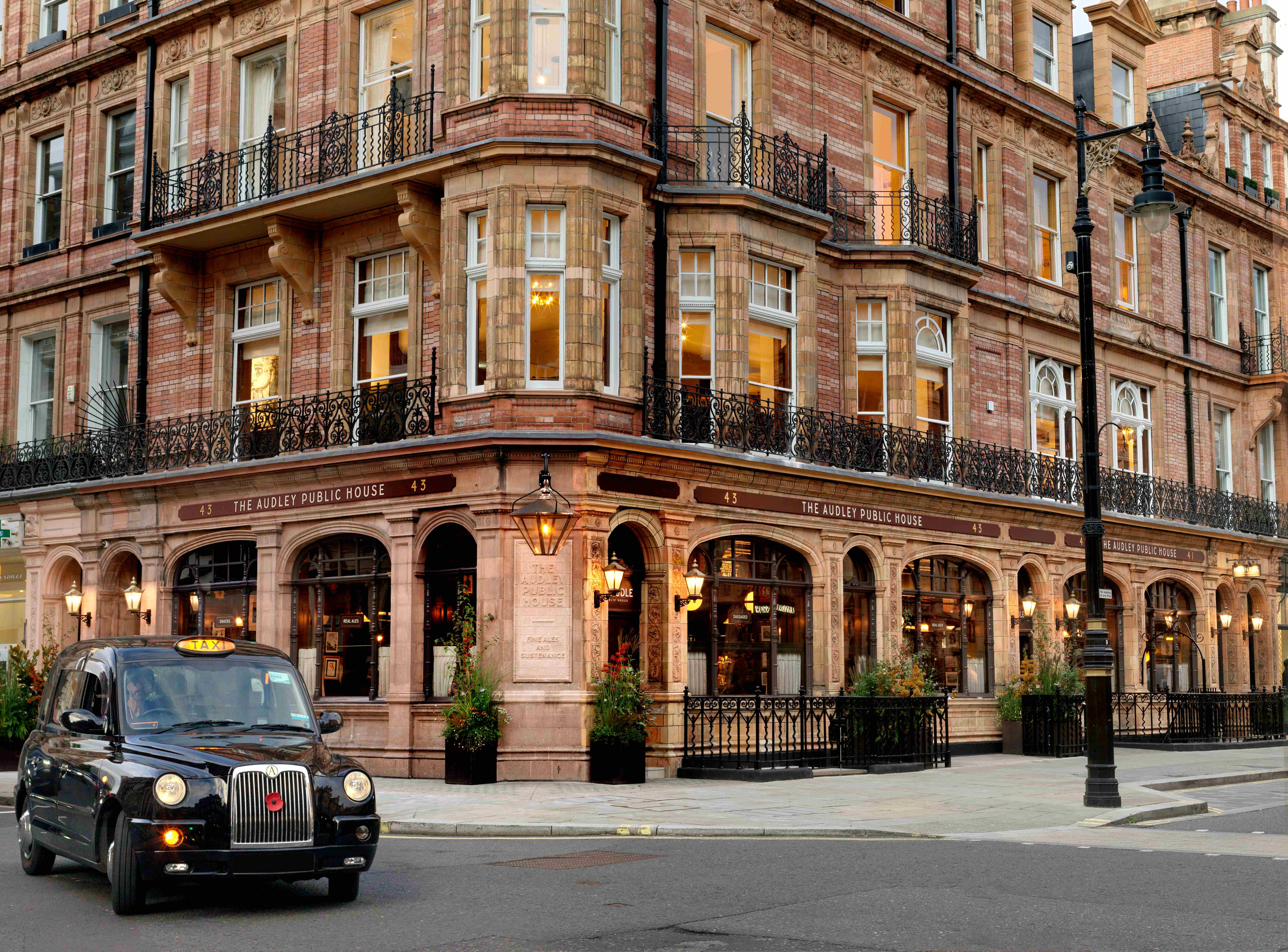 The Audley Public House on Mount Street, Mayfair - Georgian architecture with red brick facade and ornate ironwork